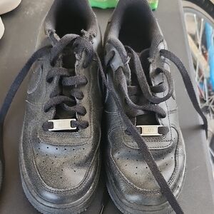 Nike Black Sneakers with Synthetic Material and Metallic Accents